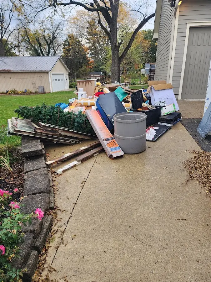 Dumpster being loaded with debris for Estate Cleanout Dumpster Rental in Fort Polk South